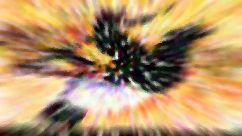 Radial verwischte Aufnahme mit gelben, orangefarbenen und pinkfarbenen Streifen, die von einer dunklen, zerfransten Mitte ausgehen.
