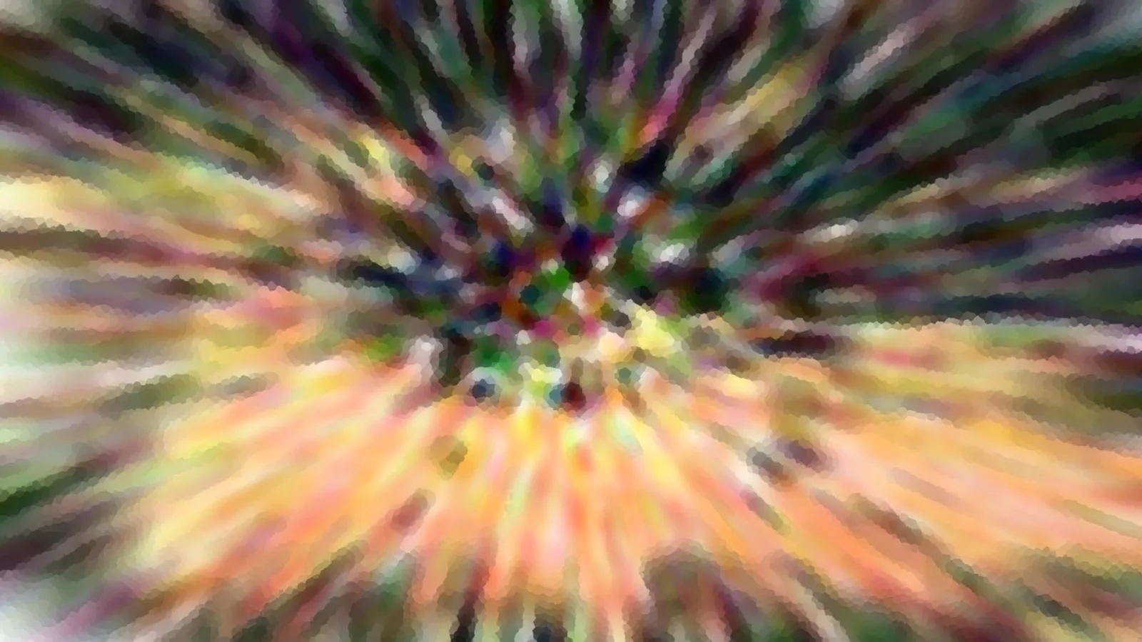 Abstrakte Aufnahme mit radialem Zoomeffekt, Farbstrahlen aus Grün, Violett, Gelb und Orange laufen von einem dunklen Zentrum nach außen.