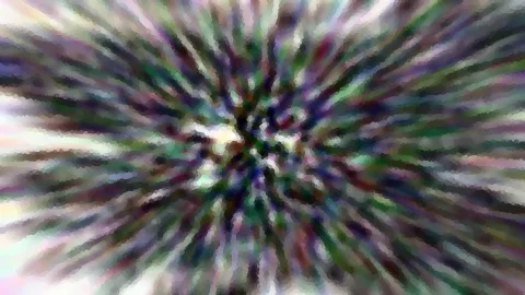 Abstrakte, bunte Streifen laufen radial von einem hellen Zentrum nach außen, unscharf und grobkörnig.