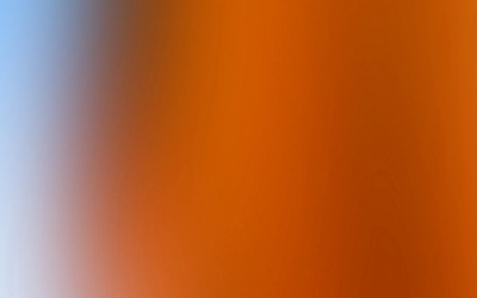 Unscharfer Farbverlauf: links helles Blau, das in der Mitte und rechts in warmes Orange und Braunorange übergeht.