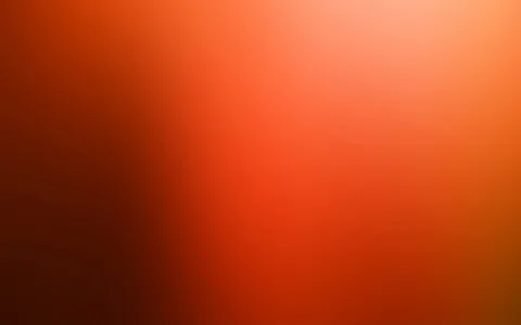 Weicher Farbverlauf von dunklem Rotbraun links zu hellem Orange und Gelb oben rechts, ohne erkennbare Motive.