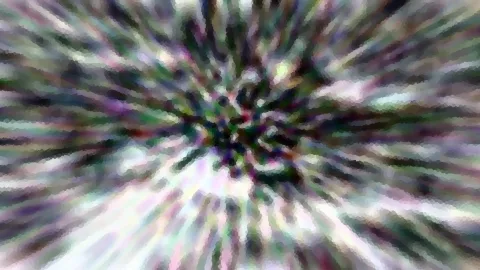 Abstraktes Bild mit radial von einem dunklen Zentrum ausstrahlenden Streifen in Grün, Violett und Weiß, stark verpixelt und verwischt.