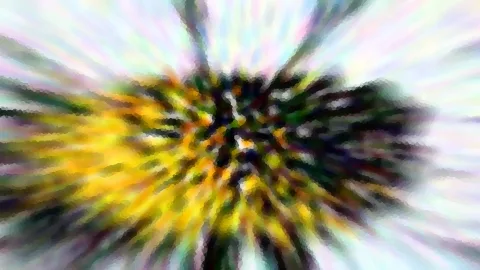 Abstraktes Bild mit radialer Zoomunschärfe, gelben und grünen Farbstrahlen laufen von einem dunklen Zentrum nach außen auf hellem, pastellfarbenem Grund.