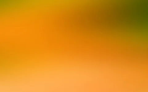 Unscharfer Farbverlauf von Orange über Gelb bis Olivgrün, oben rechts dunkler werdend