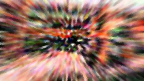 Abstraktes Bild mit radial verwischten Farbstreifen in Rot, Orange und Grün, die auf ein dunkles Zentrum zulaufen.