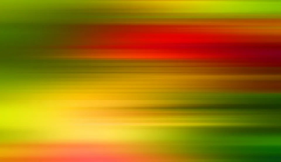 Abstrakte horizontale Bewegungsunschärfe mit Streifen in Rot, Orange, Gelb und Grün über die gesamte Bildfläche.