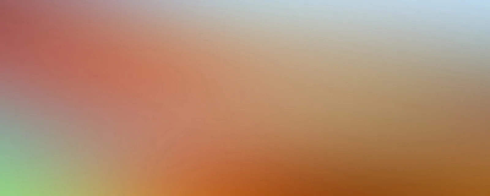 Unscharfer Farbverlauf von Korallenrot links oben über Orange bis Ockerbraun rechts unten, oben rechts blassblau, unten links hellgrün.