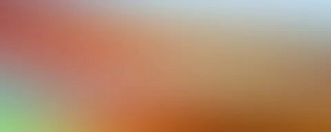 Unscharfer Farbverlauf von Korallenrot links oben über Orange bis Ockerbraun rechts unten, oben rechts blassblau, unten links hellgrün.