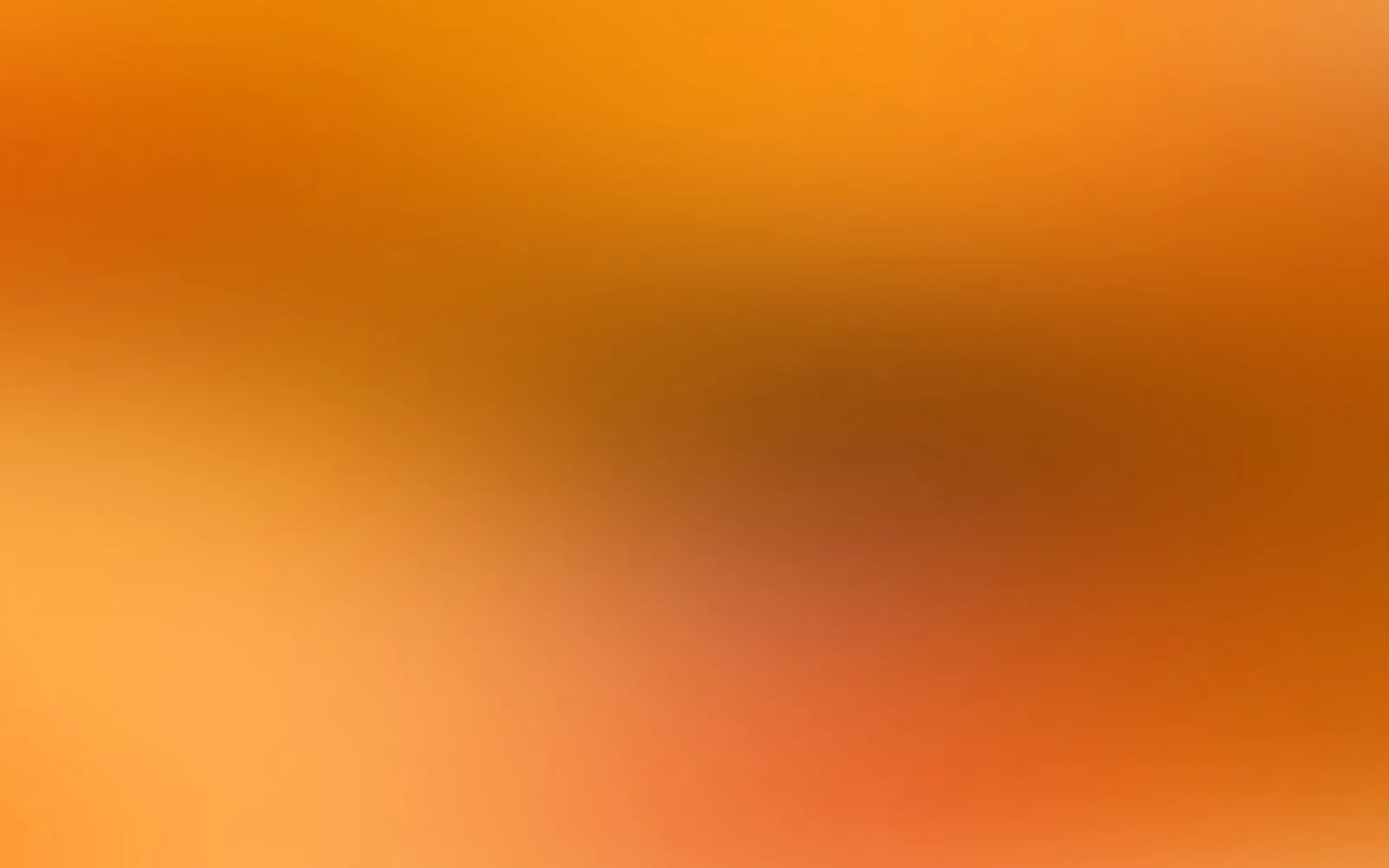 Unscharfer Farbverlauf in Orange, Gelb und Braun mit hellen und dunklen Bereichen.