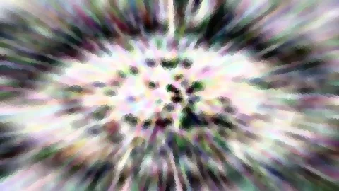 Abstraktes Bild mit radial verwischten Farbstrahlen in Rosa, Grün und Weiß, im Zentrum helle Punkte in einem Kreismuster.