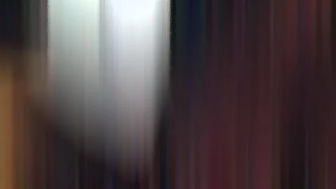 Abstrakte, vertikal verwischte Streifen: in der Mitte und links ein heller weißgrauer Bereich, rechts dunkles Rot und Violett, links unten warmes Orange.