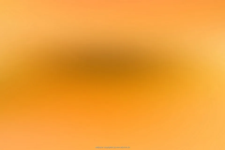 Unscharfer Farbverlauf in Orange und Gelb mit einem dunkleren, bräunlichen Bereich in der Bildmitte.