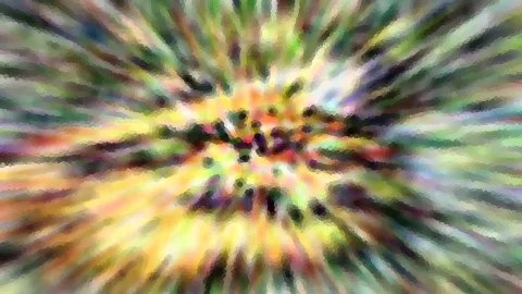 Abstrakte, radial verwischte Farbstrahlen in Gelb, Grün und Violett, die von einem dunklen, punktartigen Zentrum nach außen laufen.