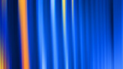 Vertikale, unscharfe Streifen in Blau mit einzelnen orangefarbenen und gelben Lichtbahnen.