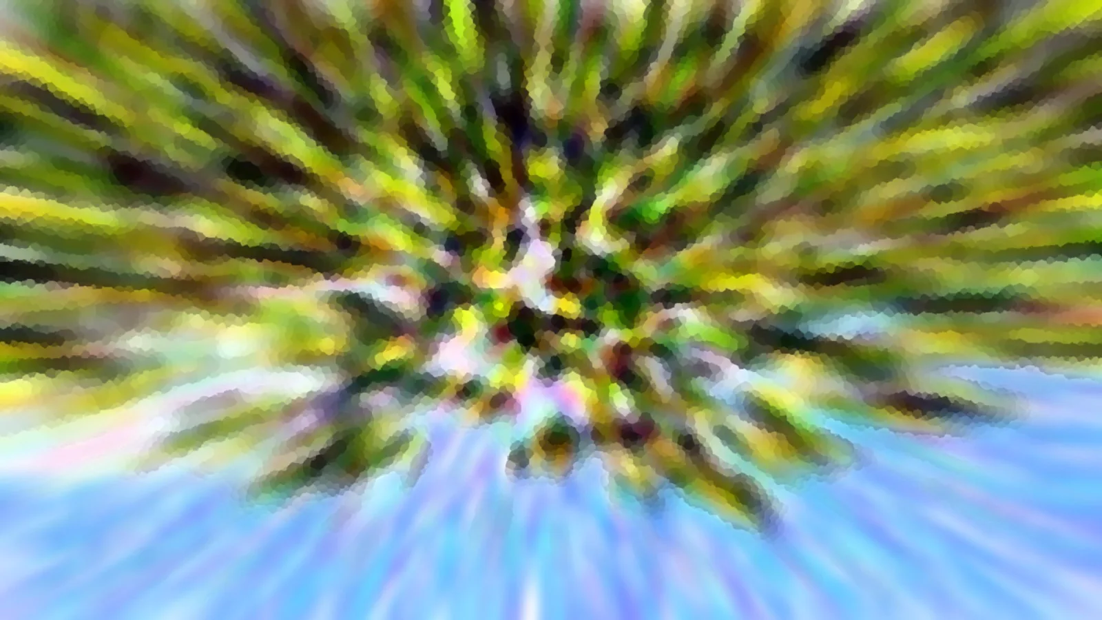Radial verwischte Aufnahme mit grünen und gelben Streifen vor blauem Himmel