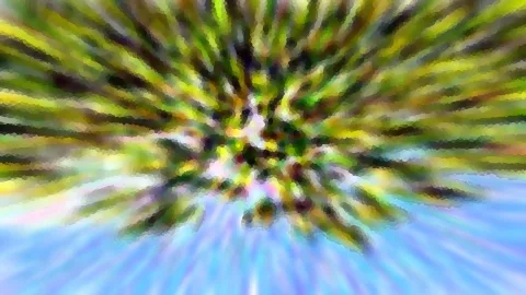 Radial verwischte Aufnahme mit grünen und gelben Streifen vor blauem Himmel
