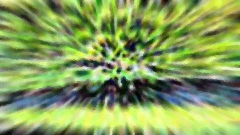 Abstrakte, radial verwischte Aufnahme mit grünen, gelben und blauen Streifen, die zur Bildmitte hin zusammenlaufen