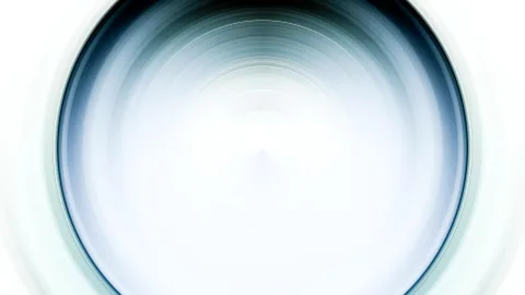 Abstrakte Aufnahme mit konzentrischen, radial verlaufenden Kreisen. Dunkles Blaugrau am Rand geht zur hellen, fast weißen Mitte über.