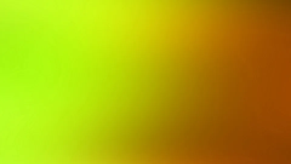Unscharfer Farbverlauf von leuchtendem Grün links über Gelb in der Mitte zu dunklem Orange rechts.