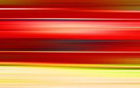 Abstraktes Bild mit horizontalen, verwischten Streifen in Rot, Orange, Gelb und Grün, unten in hellem Creme.