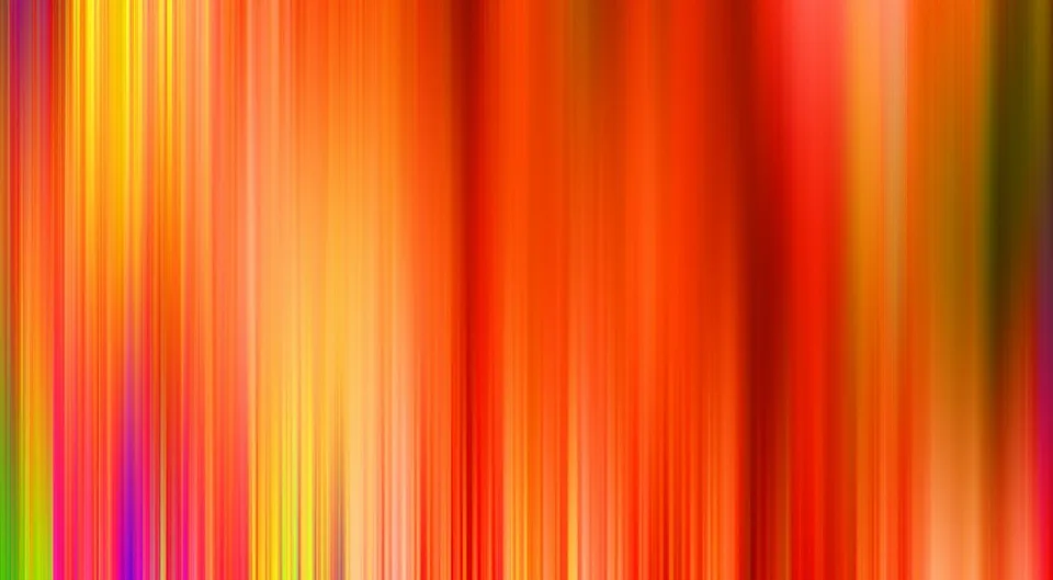 Abstrakte, vertikal verwischte Farbstreifen in Orange, Rot, Gelb und vereinzelt Magenta und Grün.