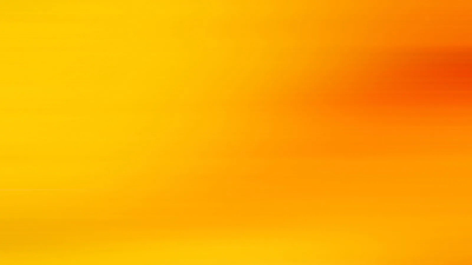 Weicher Verlauf von Gelb links zu tiefem Orangerot oben rechts, durch horizontale Bewegungsunschärfe gestreift
